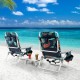 Two reclining beach chairs with tropical design and a side table, perfect for outdoor relaxation by the sea.
