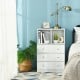 Three-drawer white dresser with cubbies, perfect for bedroom or living room storage and easy maintenance.