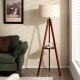 Tripod floor lamp with brown rubber wood base, linen shade, and round shelf for modern home decor and stable lighting.