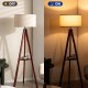 Tripod floor lamp with brown wooden base and flaxen shade, showcasing on/off light functionality for modern home decor.