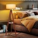 Tripod floor lamp with a brown wooden base and flaxen lampshade, perfect for modern home decor and easy assembly.