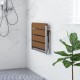 Wall-mounted foldable bathroom bench in waterproof HIPS material with stainless steel frame, ideal for space-saving use.