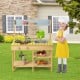 Backyard pretend play toy kitchen with stove top, solid pine wood, multiple shelves, ideal for outdoor play.