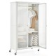 Rolling storage armoire closet in white with hanging rod, adjustable shelf, and wheels for easy movement in bedrooms.