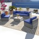 L-shaped 6 piece patio conversation sofa set with navy cushions and tempered glass coffee table for outdoor relaxation.