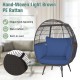Oversized light brown PE rattan egg lounge chair with navy cushions, perfect for cozy indoor or outdoor relaxation.