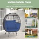 Oversized rattan egg lounge chair with navy cushions, ideal for indoor and outdoor relaxation in various settings.
