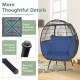 Oversized patio rattan egg lounge chair with navy cushions, featuring adjustable footpads and sturdy X-shaped structure.