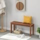 Backless dining bench for two with a slatted seat in solid wood, offering a rustic charm for patio or porch settings.