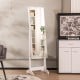 Freestanding jewelry cabinet in white featuring a full-length mirror, adjustable LED lights, and a lockable door for.