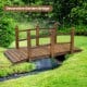 5-foot wooden garden bridge with safety rails in brown, perfect for enhancing backyard and garden aesthetics.
