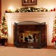 Three-panel foldable fireplace screen in black wrought iron, providing safety from sparks and embers in the living room.