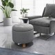 Round gray upholstered ottoman with solid rubber feet, featuring storage space and cushioned seat for versatile use.