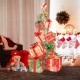 Colorful stacked lighted Christmas gift boxes with vibrant bows and warm white lights, creating a festive atmosphere.