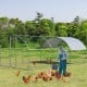 Large metal chicken coop with galvanized steel frame and waterproof cover, ideal for backyard poultry protection.