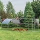 Large metal chicken coop with galvanized dome cage and waterproof cover, ideal for outdoor use in your backyard.