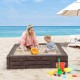 Kids playing in the 2-In-1 HDPE brown sandbox with cover, perfect for outdoor fun and creativity by the beach.