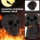 Realistic black ceramic skull decoration with spooky details, designed for fire pits, creating a creepy Halloween.