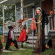 Life-size animatronic witch with red eyes and posable arms, perfect for Halloween parties and outdoor decorations.