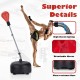 Freestanding adjustable punching bag in red with breathable gloves, featuring a durable base and high elastic spring.