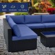 L-shaped outdoor wicker conversation set with navy cushions, featuring durable PE rattan and a tempered glass tabletop.