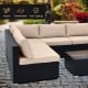 L-shaped outdoor wicker conversation set with beige cushions, featuring durable PE rattan and a tempered glass tabletop.