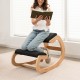 Wooden rocking chair with padded seat cushion in black, designed for comfort and improved posture while reading.