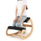 Wooden rocking chair with black padded seat cushion, designed for posture improvement and comfort during use.