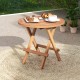 Round patio folding coffee table made of teak wood, featuring a slatted tabletop, perfect for outdoor use.