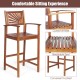 Outdoor acacia wood bar chair with sunflower backrest and armrests, designed for comfort and stability on patios.