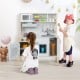 Wooden pretend play kitchen set for toddlers in white, featuring realistic appliances and cooking accessories for.