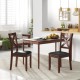 Set of 2 wooden dining chairs with padded black seats and rubber wood legs, perfect for kitchen or dining room use.
