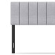 Gray linen upholstered headboard with vertical channel tufting and solid rubber wood legs, adjustable for full or queen.