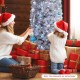 A family decorates a 6 ft pre-lit artificial Christmas tree with black and white leaves, surrounded by festive gifts.