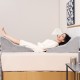 Triangle bed wedge pillow in gray, providing back support for reading or relaxation, with a detachable plush cover.