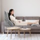 Adjustable orthopedic wedge pillow set in gray, providing ergonomic support for back, neck, and legs on a sofa.
