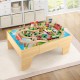 Wooden train set with reversible tabletop, featuring 84 pieces, gas station, and helicopter pad for imaginative play.