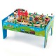 Colorful 80-piece wooden train set on a table with tracks, buildings, and accessories for imaginative play and fine.