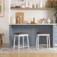 Two 24-inch bar stools with padded seats and wood legs, perfect for kitchen or dining room use.