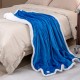 Soft blue heated electric blanket throw with sherpa fleece, featuring 10 heat levels, draped over a bed for cozy warmth.