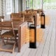 Double-sided black aluminum heater with carbon fiber heating, ideal for outdoor use, providing warmth in a patio.
