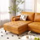 L-shaped brown sectional sofa with tufted air leather, plush cushions, and bolster pillows for living room comfort.