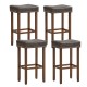 Set of four saddle-shaped upholstered bar stools with gray PU leather and natural rubber wood legs for versatile use.
