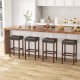 Saddle-shaped gray upholstered bar stools with footrests, featuring natural rubber wood legs, ideal for kitchen islands.