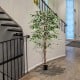 Tall artificial ficus tree with 1008 leaves and a solid wood trunk, perfect for home or office decor.