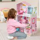 Kids playing with a pink wooden dollhouse featuring 5 rooms and movable furniture for imaginative play.