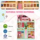 Three-story pink dollhouse playset with 15 furniture pieces, featuring BPA-free natural wood material for kids' play.