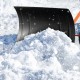 29-inch snow pusher with ergonomic handle and large wheels, designed for efficient snow removal on driveways.