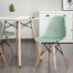 Green plastic hollow chair with wood legs, featuring ergonomic design and breathable mesh for dining room use.