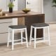 Set of 2 gray upholstered 26-inch counter height bar stools with saddle seats and rivet accents for kitchen use.
